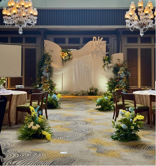Wedding backdrop with floral arrangements and chandeliers